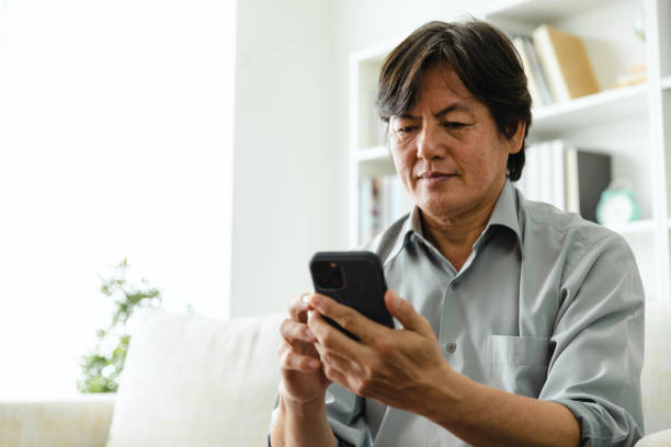 istock Man enjoy social media using mobile phone at home. 1424271579