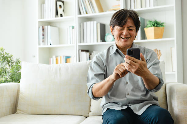 istock Man enjoy social media using mobile phone at home. 1424271583