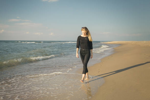 istock sad woman walking 1424272489
