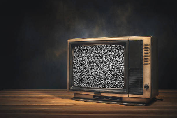 istock Vintage old TV set is still life with static screen in the dark room. 1424274155