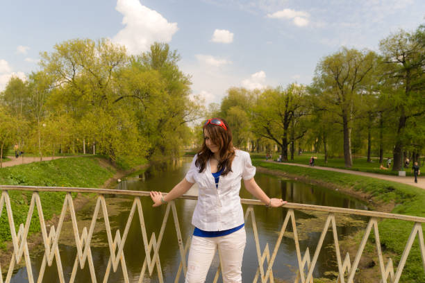 portrait of teenager girl on the bridge in spring park