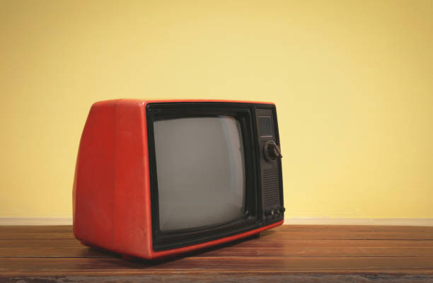 istock Vintage, Retro red old tv on wooden table 1424274667