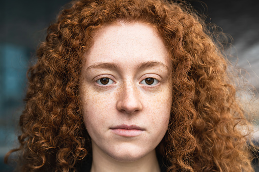 Closeup portrait of redhead girl looking at camera