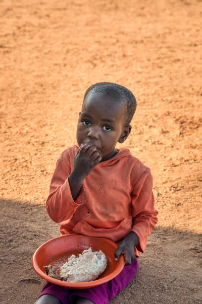 istock African child eating 1424277438