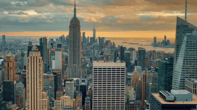 New York City skyline with urban Manhattan skyscrapers at sunset, USA.