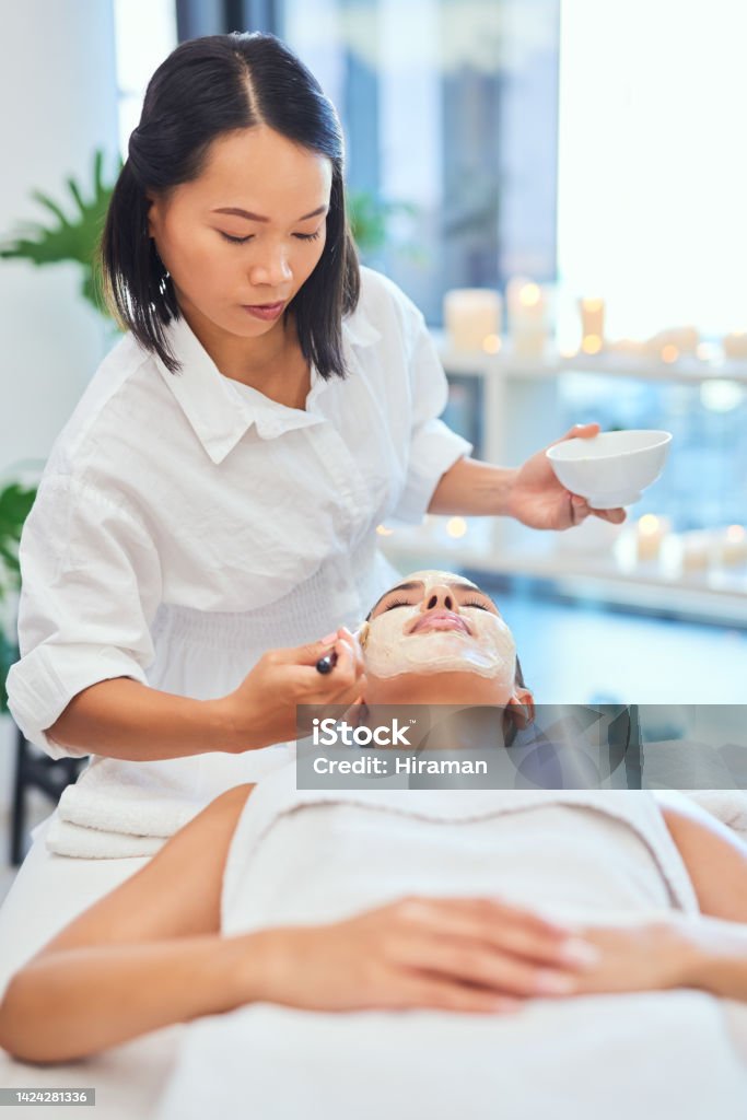 Spa facial beauty and wellness luxury treatment by professional skincare expert to a woman for a healthy face. People, oil and zen lifestyle at expensive, wealthy and rich resort for cosmetic therapy Expertise Stock Photo
