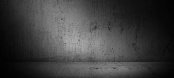 istock Dark concrete wall and floor background with light, three dimensional room for mock up or product display 1424282121