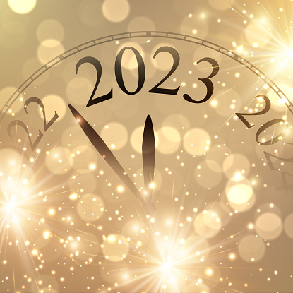 Christmas clock showing 2023 with golden firework and bokeh lights. Happy new year.