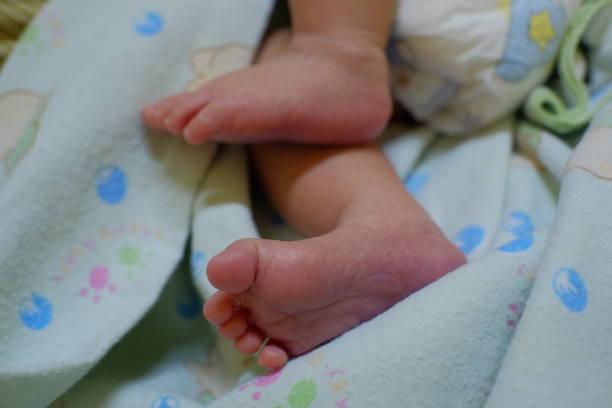 istock The baby's feet are less than a week old, still look fragile 1424282772
