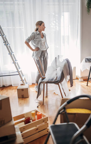 istock Woman moving in new home 1424287185