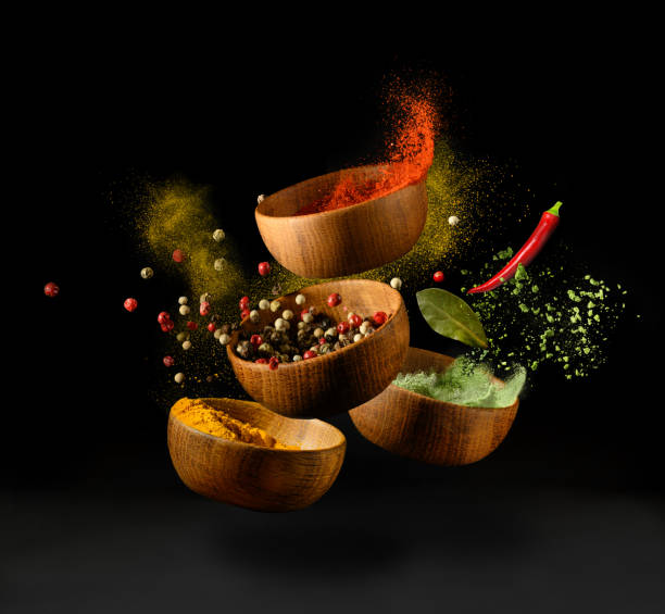 spices and seasonings powder splash, explosion on black background - indian culture spice cooking herb imagens e fotografias de stock