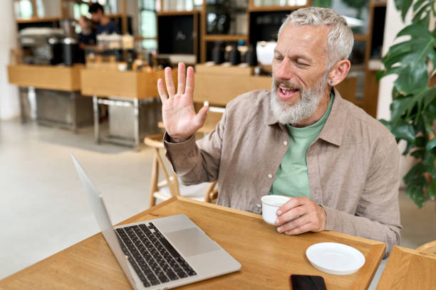 istock Happy older business man using laptop computer remote working by video call. 1424287871