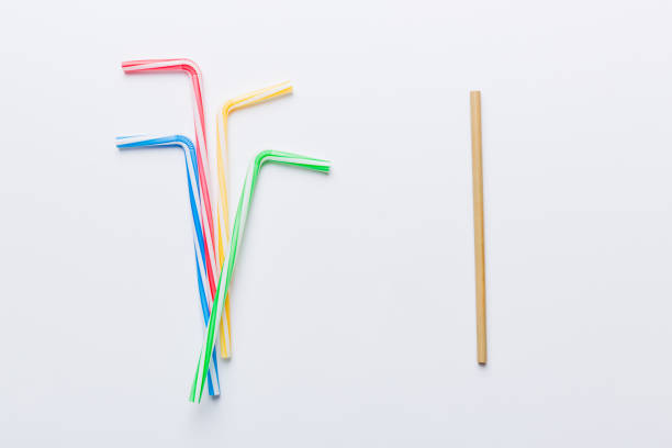 istock Drinking straws for party on Colored background. Top view of colorful plastic disposable straws for summer cocktails. different straws for juice with copy space 1424295209