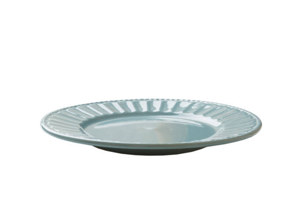 istock Blue ceramic round plate isolated over white background. perspective view 1424295216