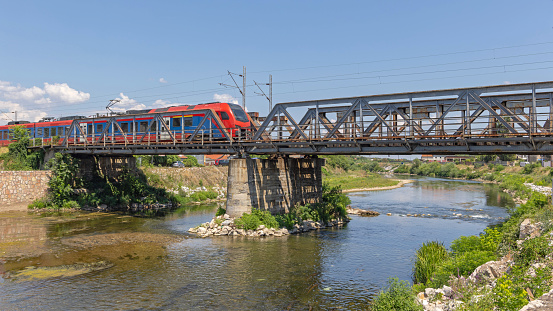 Urban Transport Train at Bridge Over River Summer Day