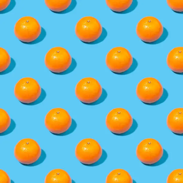 Seamless background with tangerines - absolutely seamless pattern with orange tangerines on a blue background