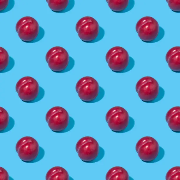 Seamless background with plums - absolutely seamless pattern with plums on a blue background