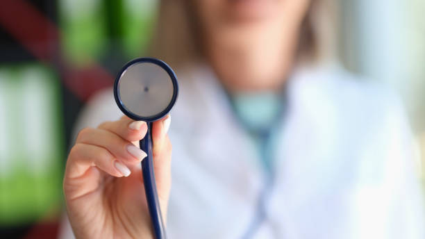 Closeup of cardiologist doctor holding a stethoscope stock photo