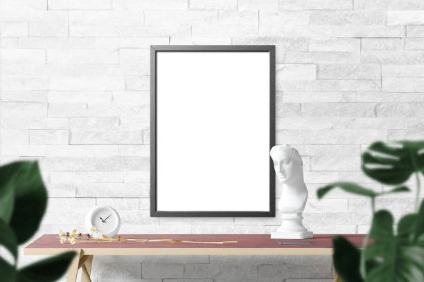 istock Clean minimal frame mockup on the wall with desktop and leaves 1424304375
