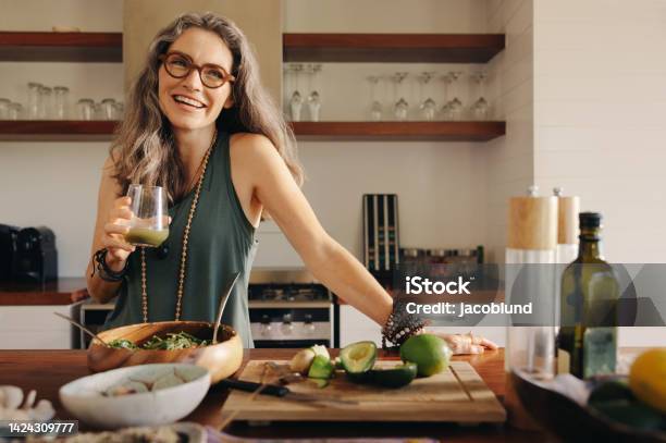 Healthy Senior Woman Smiling While Holding Some Green Juice Stock Photo - Download Image Now