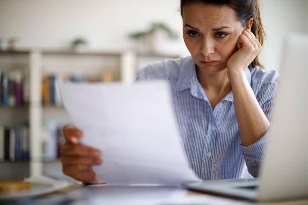 Worried mature woman about home finances stock photo
