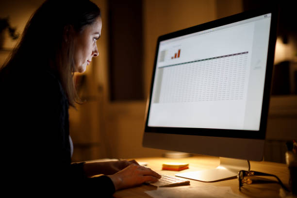 istock Serious woman working late at home 1424309901