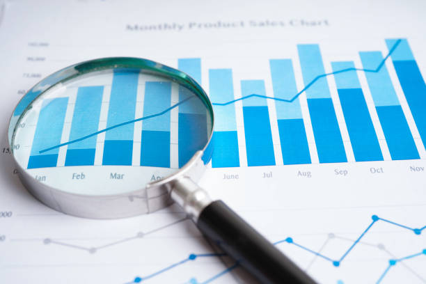 istock Magnifying glass on charts graphs paper. Financial development, Banking Account, Statistics, Investment Analytic research data economy. 1424312695