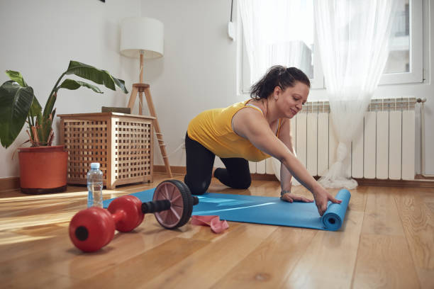 istock Woman training inside the living room, exercising at home. 1424313640
