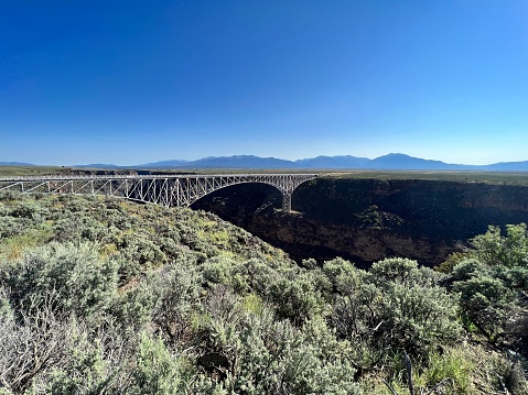Distant shot of the Rio Grand gorge, bridge and mountains