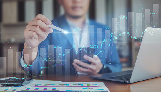 Business data analysis, financial investment and growing graph, stock graph analysis, business people on desk with graph analysis on visual screen.