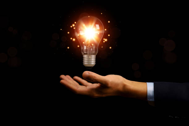 istock businessman holding a light bulb graphic Digital technology abstract. imagine an idea Creative and innovative. brain to brainstorm ideas in business. Strategies for development, growth, and success 1424315381