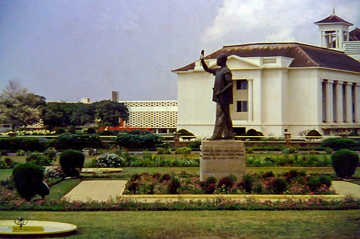 Accra, Ghana - 1960: The statue of President Kwame Nkrumah in front of Parliament House in Accra, Ghana c.1960