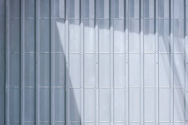 istock Background of gray sheet metal garage wall with sunlight and shadow on surface 1424323765