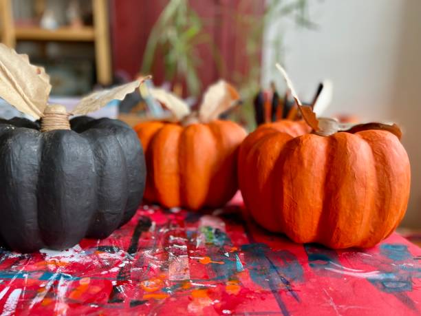 istock Papier Mache Pumpkins Painting in Progress 1424323800