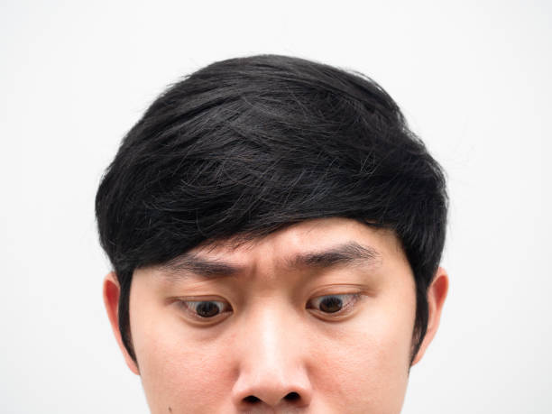 istock Close up face asian man looking down portrait head shot 1424326924