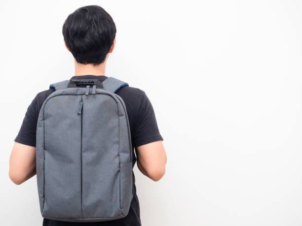 istock Man with school backpack stand turn back copy space white background back to school concept 1424327486