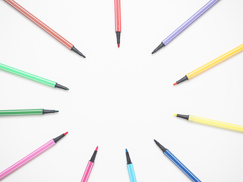 Close up color pen different array circle on white isolated top view copy space
