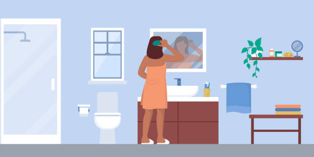 Woman brushing hair in the bathroom Young woman brushing hair in the bathroom after having a shower, domestic room interior vanity mirror stock illustrations