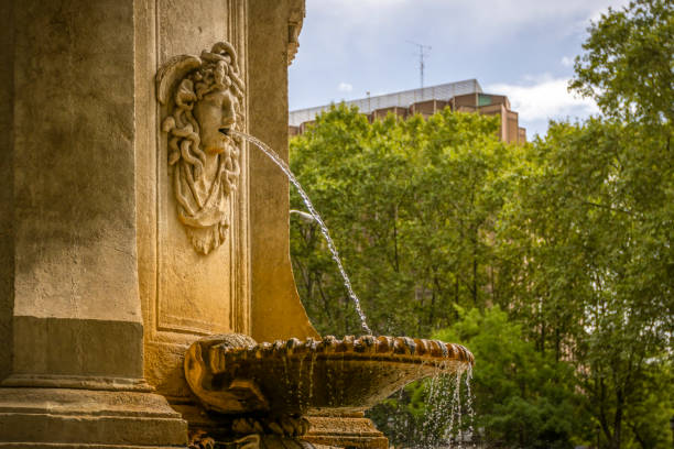 Historic water fountain in the center of Madrid, Spain. It is part of a group of fountains, in this one is sculpted in stone the head of the Gorgon Medusa.