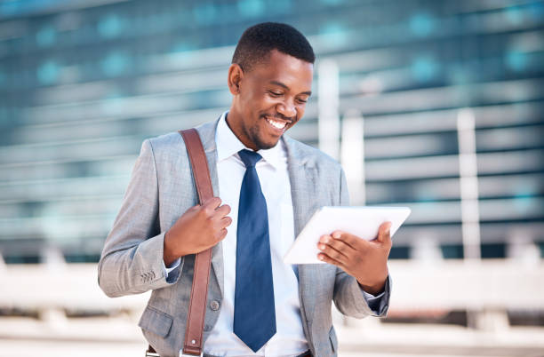 istock Black man, city business and digital tablet for online planning, internet and web apps technology outdoors. Happy entrepreneur, smile corporate worker and african executive manager connect urban wifi 1424336322