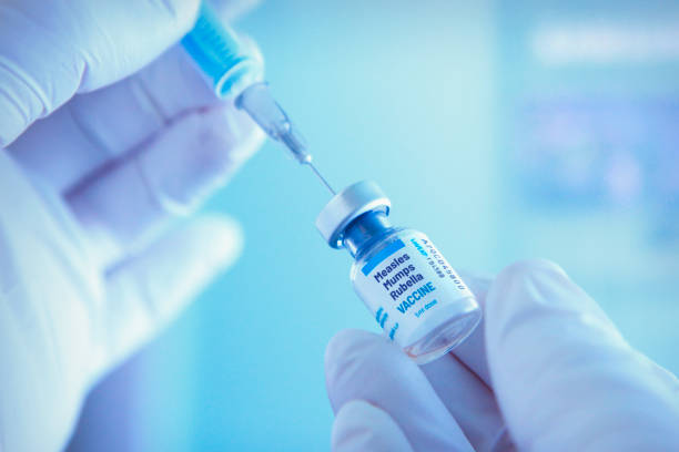 Measles, mumps and rubella vaccine Medical worker prepareing measles, mumps and rubella vaccine for vaccination measles stock pictures, royalty-free photos & images