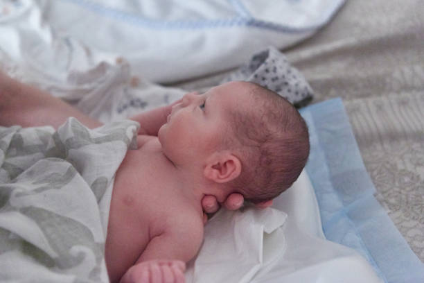istock Newborn baby boy lying down on bed 1424340416