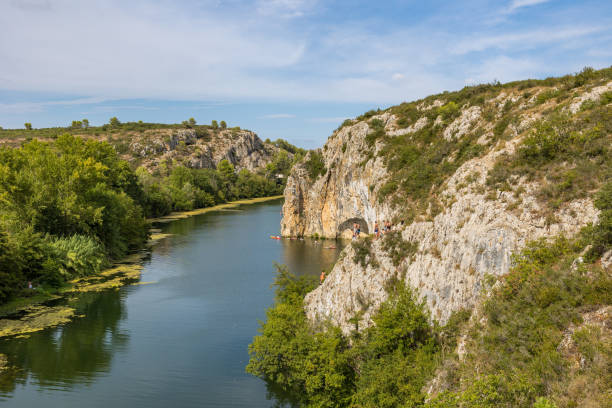 View of a meander of the Vidourle River and the Roque de Saint-Sériès in summer stock photo