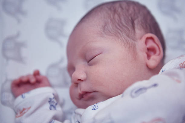 istock Newborn baby boy sleeping in a crib 1424340835