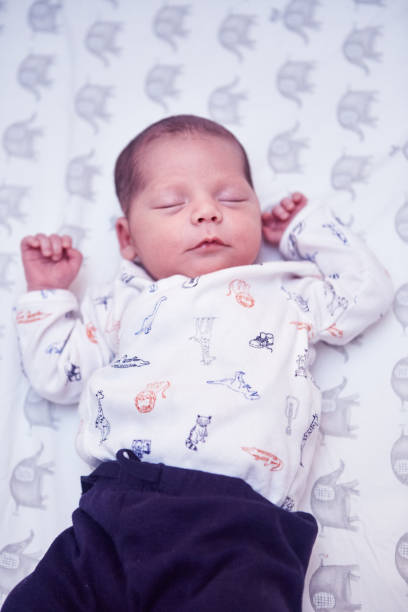 istock Newborn baby boy sleeping in a crib 1424340859