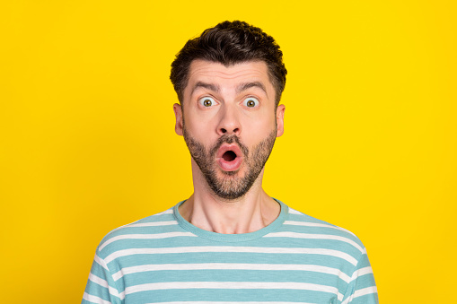 Closeup photo of young attractive guy excited now know secret you were hiding isolated on yellow color background.
