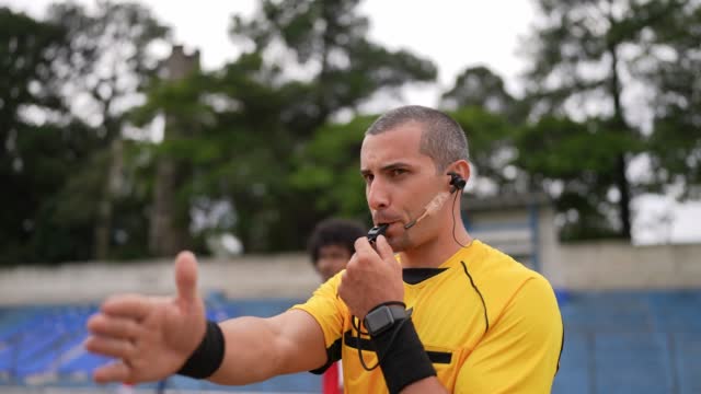 Referee whistling to start or ending soccer match