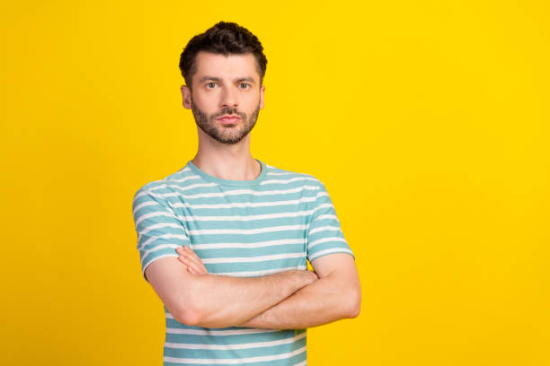 istock Portrait photo of young confident attractive man hands folded professional it programmer isolated on yellow color background 1424342371