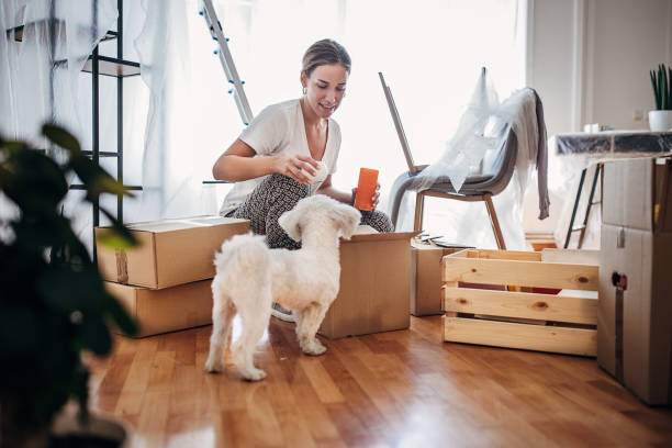 istock Woman unpacking in new home 1424343783