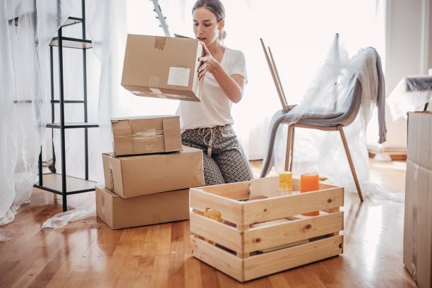 istock Woman unpacking in new home 1424343797